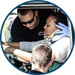 EMTs with patient in neck brace