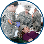 Military personnel working on accident victim
