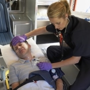 EMT working on patient in ambulance