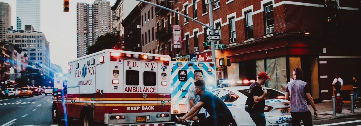 Ambulance on a crowded street corner