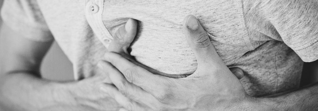 Man clutching his chest in pain