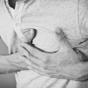 Man clutching his chest in pain
