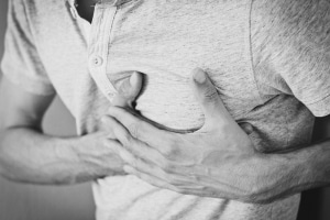 Man clutching his chest in pain