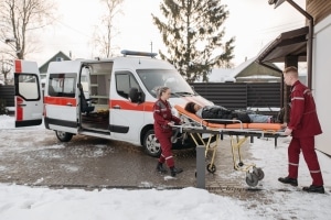 Paramedics transporting a patient in the snow