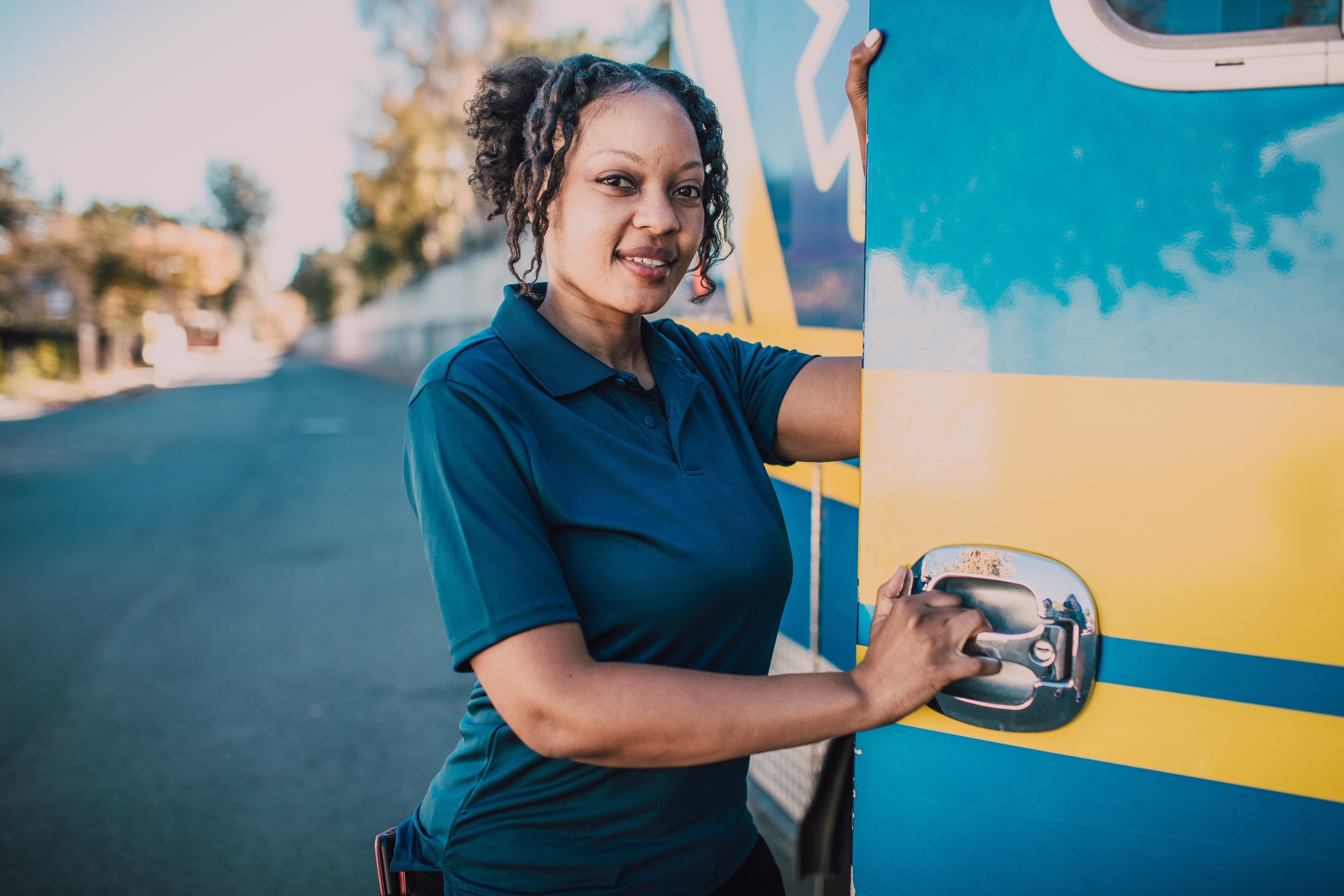 African-American paramedic standing by an ambulance