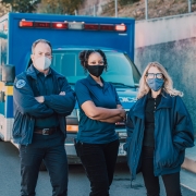 EMS professionals in front of an ambulance