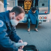Masked paramedic retrieving supplies