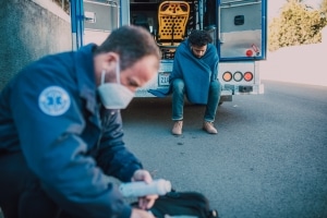 Masked paramedic retrieving supplies