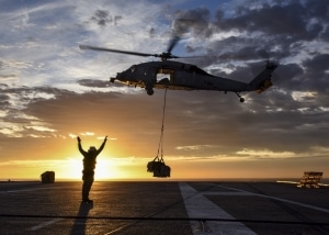 Military helicopter delivering supplies