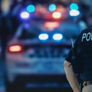 Police officer standing in front of a patrol car