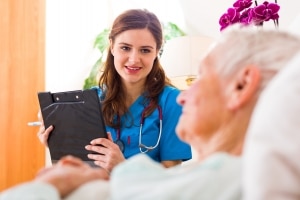 Healthcare professional speaking with an elderly patient