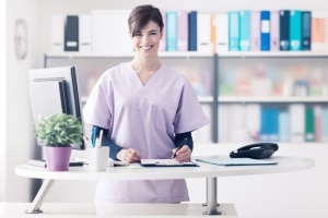 Female medical professional working at a desk