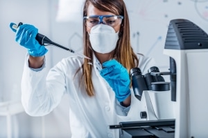 Forensic technician performing lab tests