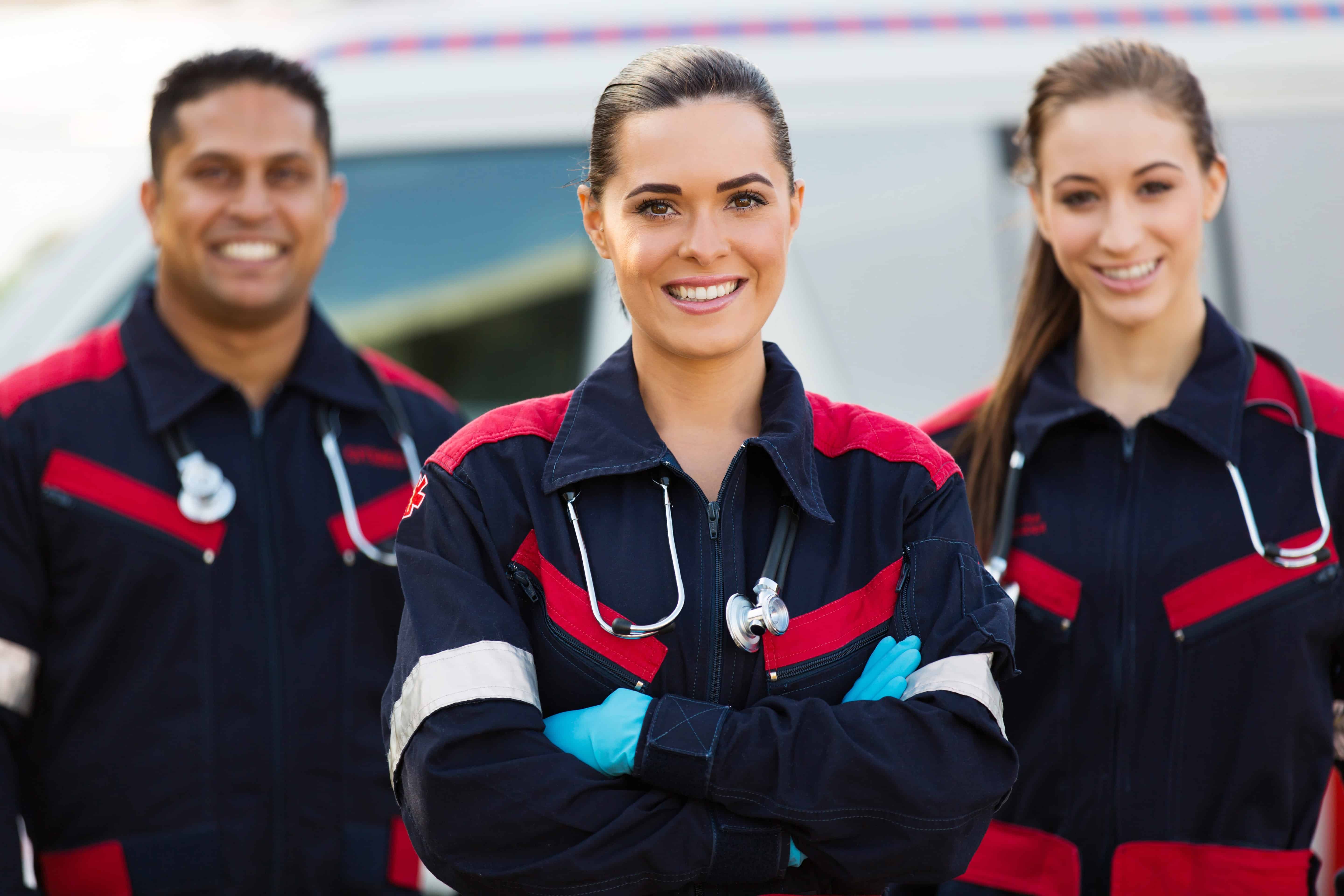 Young EMTs in front of an ambulance