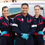 EMS professionals in front of an ambulance