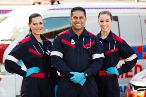 EMS professionals in front of an ambulance