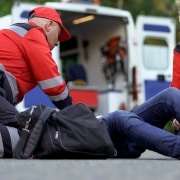 EMS team helping a patient on the road