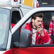 Male EMS professional using a portable radio