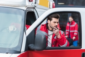 Male EMS professional using a portable radio