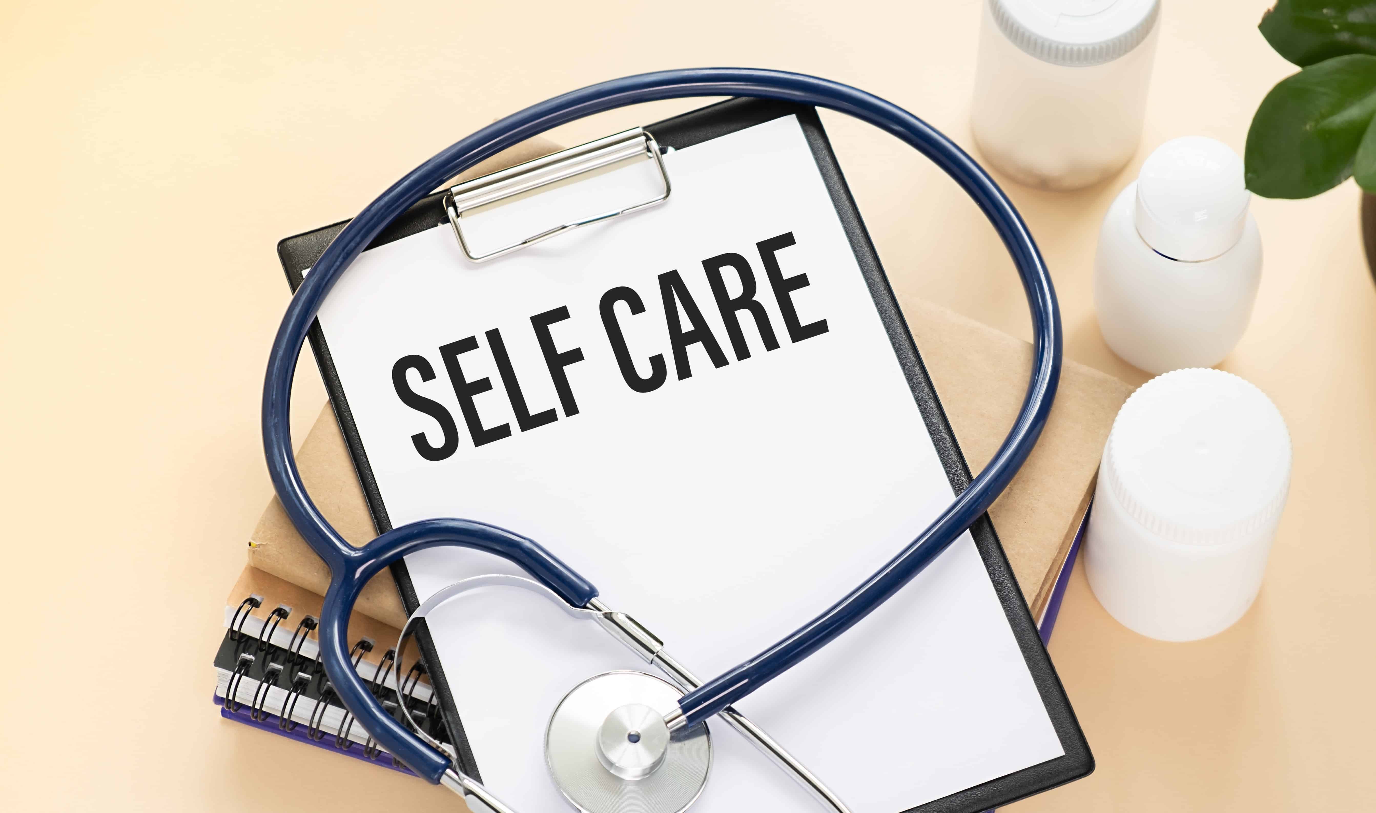 Self care written on a clipboard