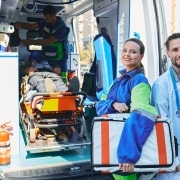 Medical workers standing beside an ambulance
