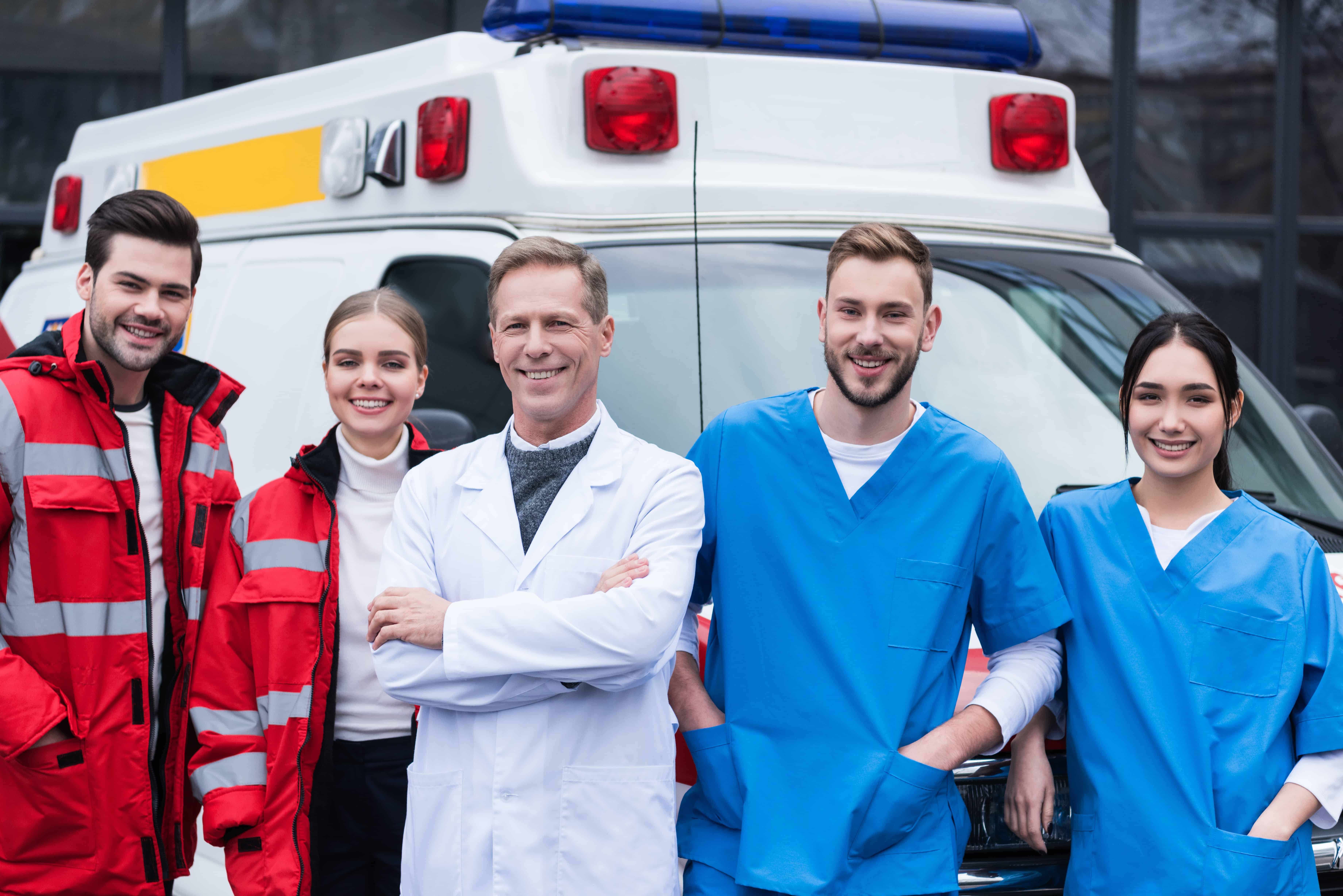 Team of medical workers beside an ambulance