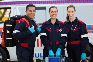 Group of EMS professionals next to ambulance