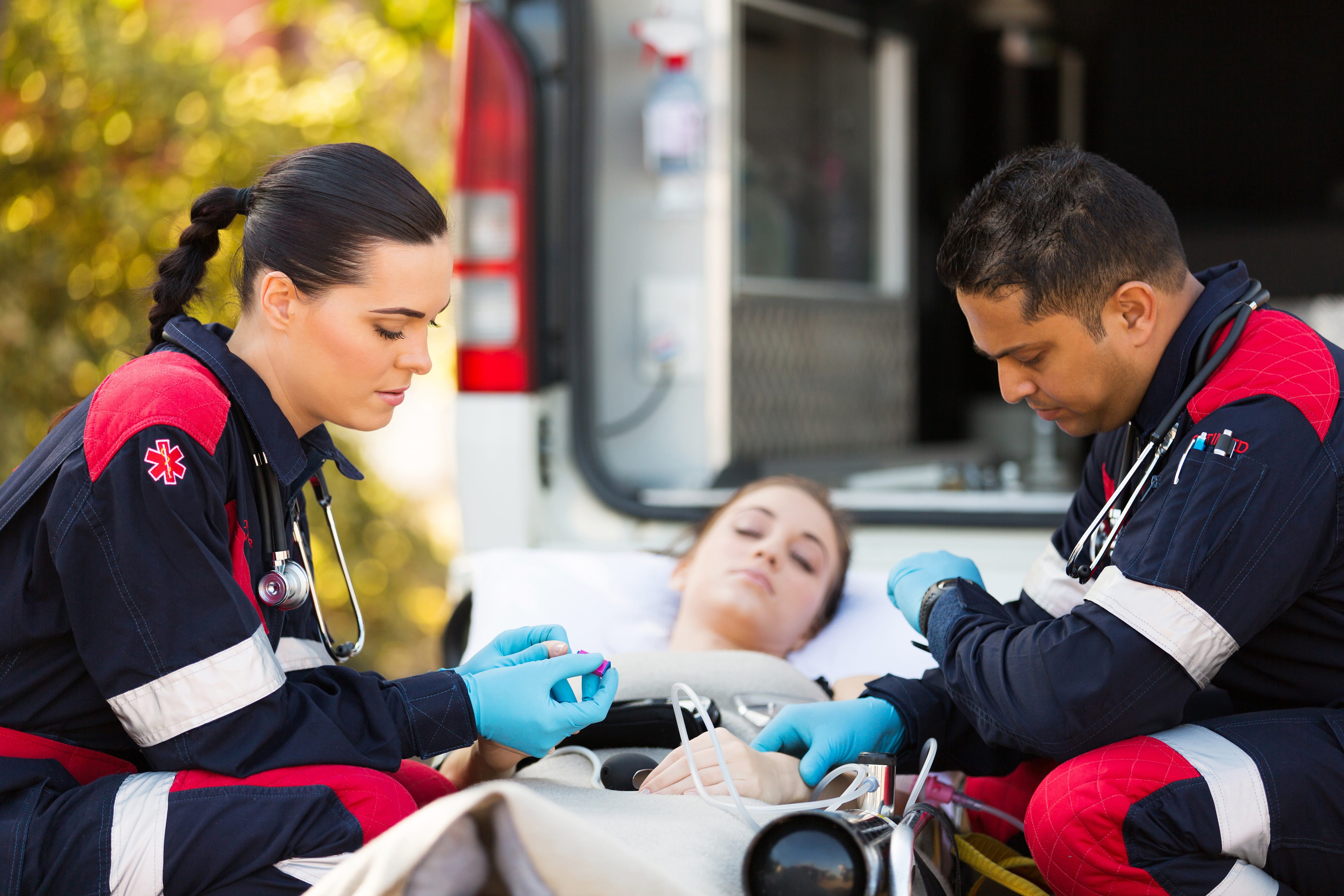 EMS professionals assisting a woman
