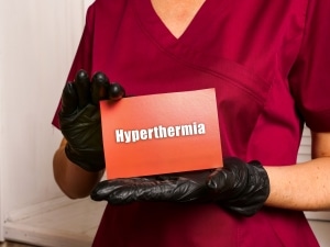 Medical worker holding a sign that says hyperthermia