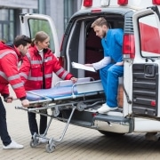 EMS professionals moving a stretcher