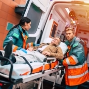 EMS professionals transporting a stretcher