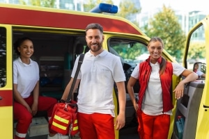 Three smiling EMS professionals