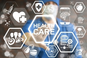 Healthcare technology logos in front of blurred healthcare worker
