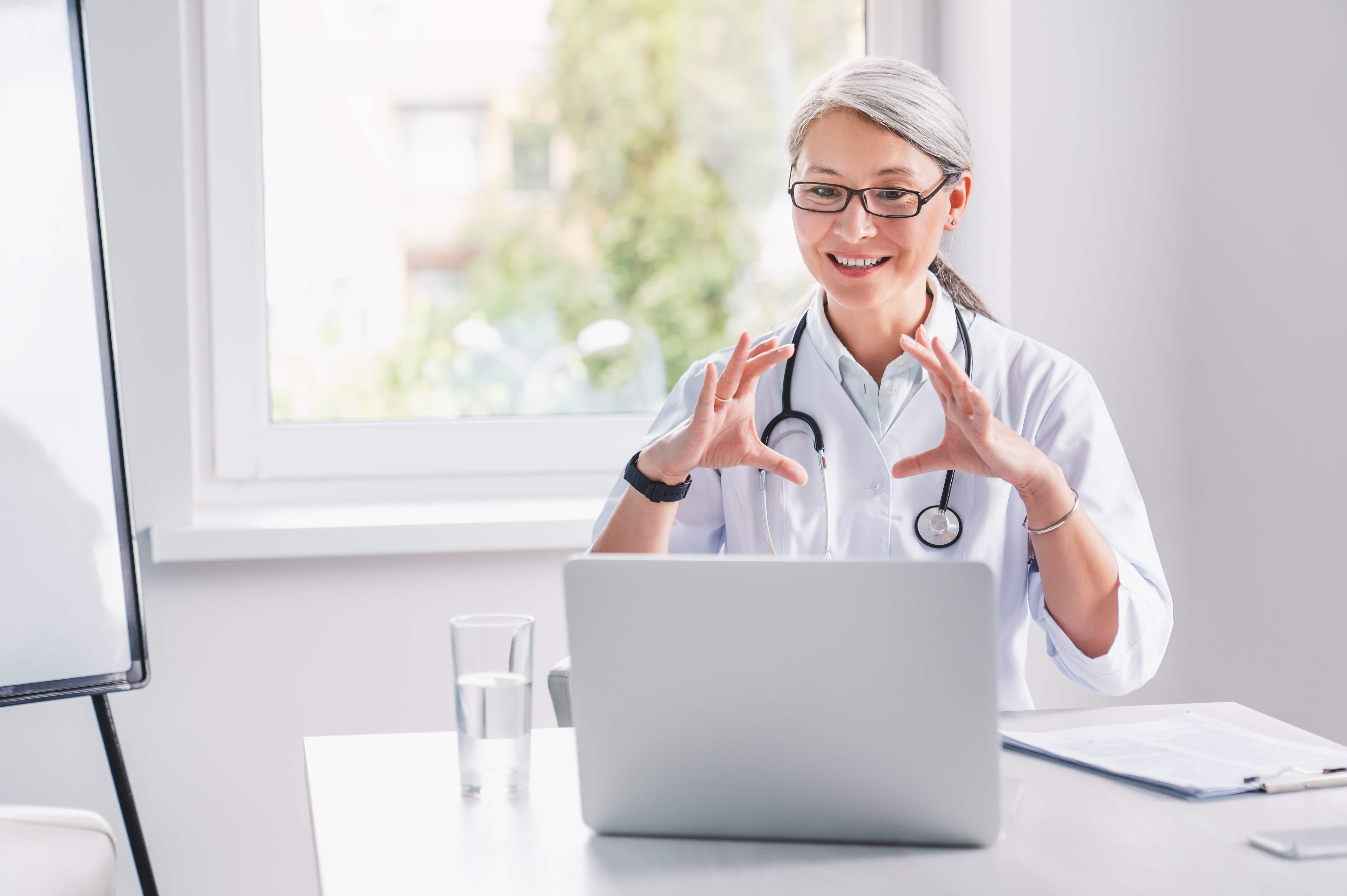 Asian medical professional using a laptop for telemedicine